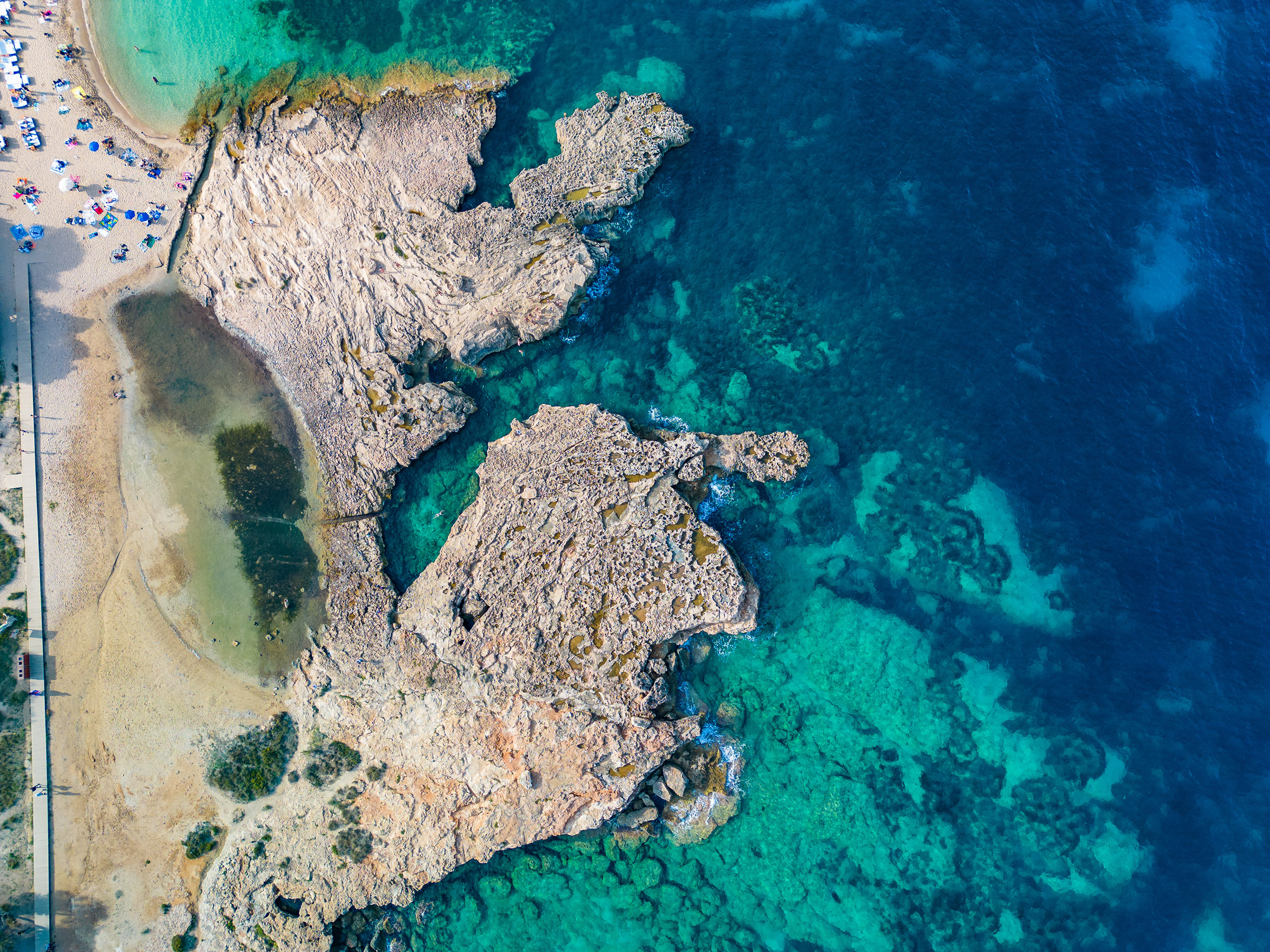 Het strand van Cala Bassa, Ibiza met helblauw water